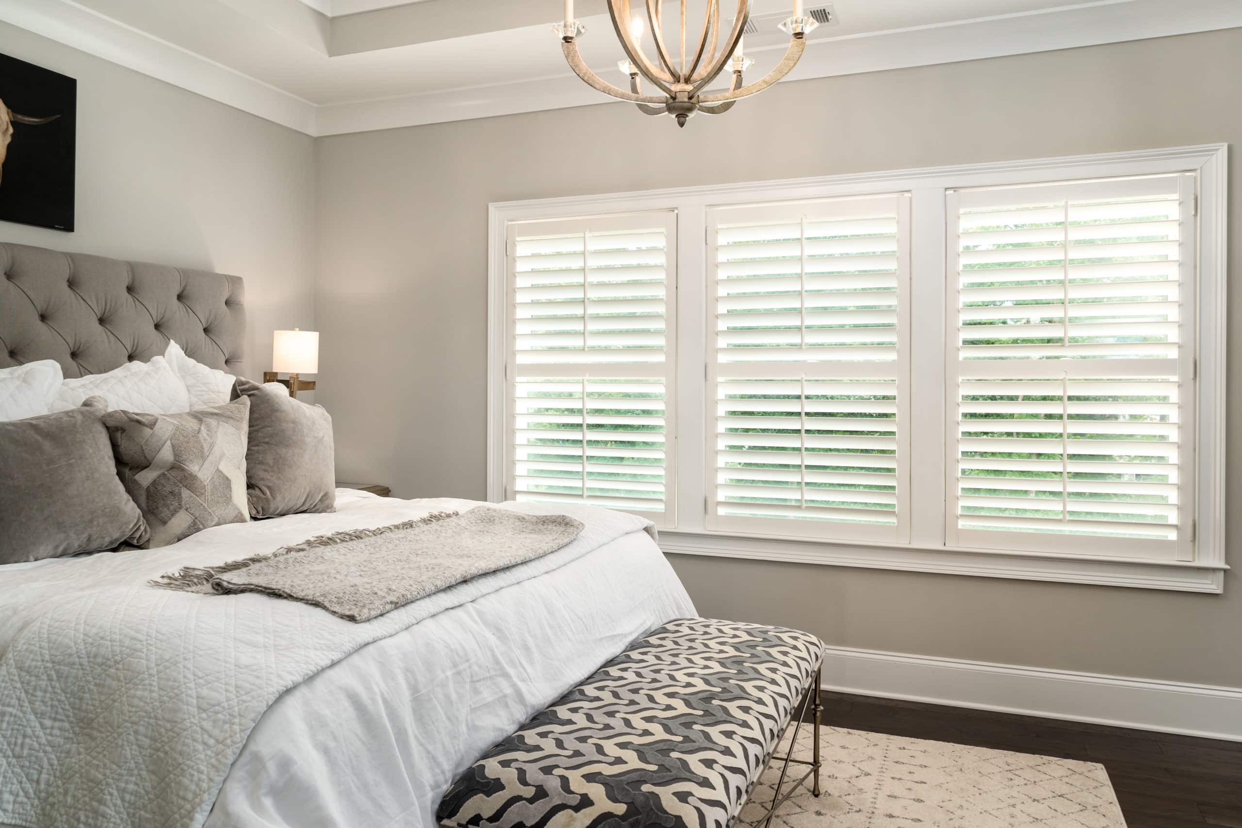 Hardwood Plantation Shutters on three windows featuring 3.5 inch louvers and split tilt rods, in a Sandy Springs, GA bedroom