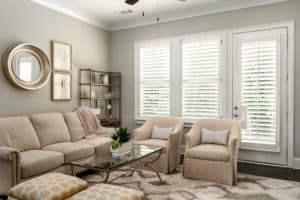 White Hardwood Plantation Shutters featuring 3.5 inch louvers and divider rails in a cozy Sandy Springs, GA living room