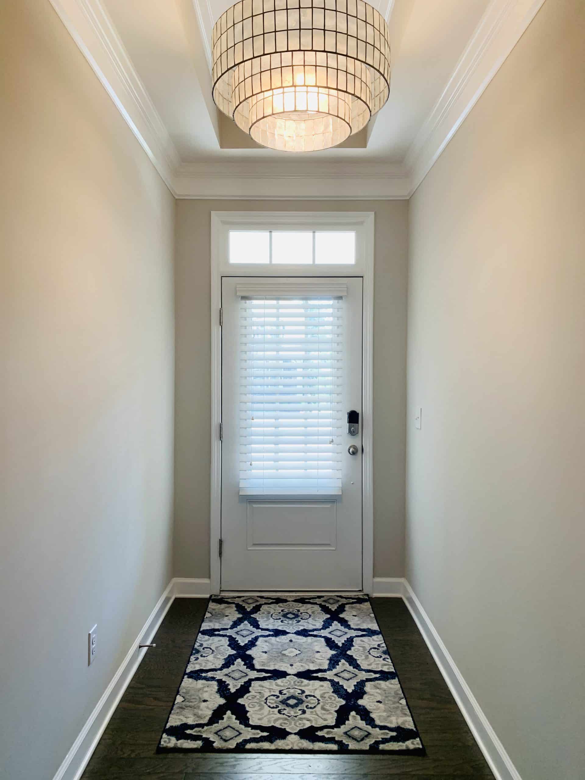 White, Real Wood Blinds on a front door window, featuring 2.5' slats, and light-filtering capability in Cumming, GA