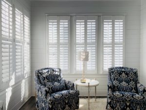 Hardwood Plantation Shutters featuring 3.5 louvers and split tilt rods in a white, brightly-lit Atlanta, GA sunroom