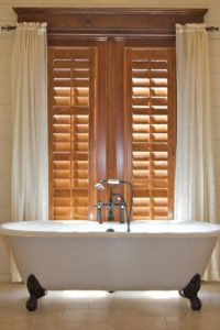 Dark-Stained, Hardwood Plantation Shutters with 3.5 inch louvers and single tilt rods in an Atlanta, GA bathroom