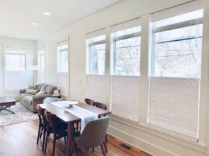 Natural Woven Shades, also known as Tropical Woven Shades, with top down, buttom up lift functionality in a spacious, white-walled living and dining space in Nashville, TN