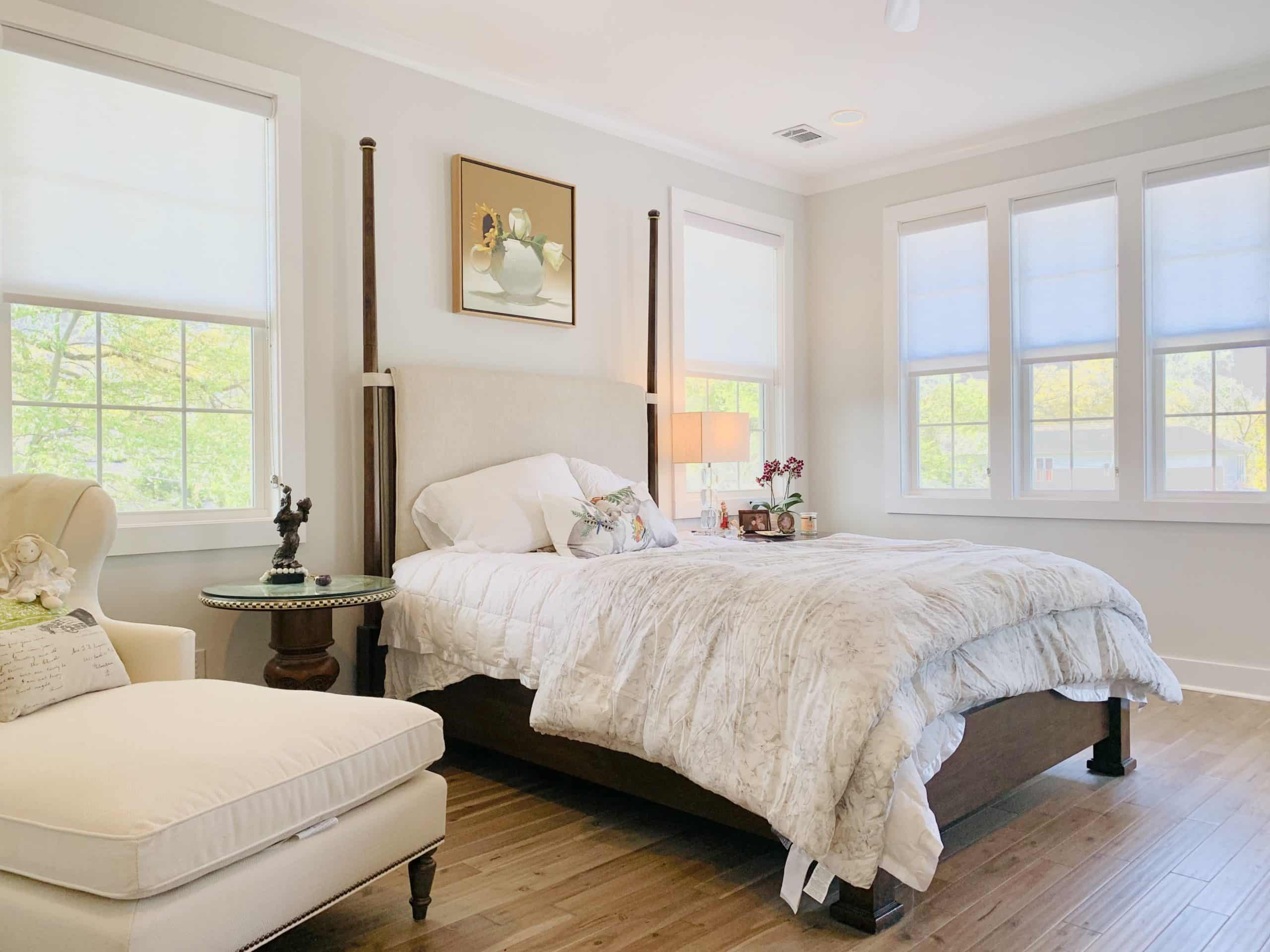 Gray Roller Shades gently diffuse light into a white-trimmed Atlanta, GA master bedroom