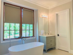 Custom, Cordless Roller Shades lifted to expose windows in a Dunwoody, GA master bathroom