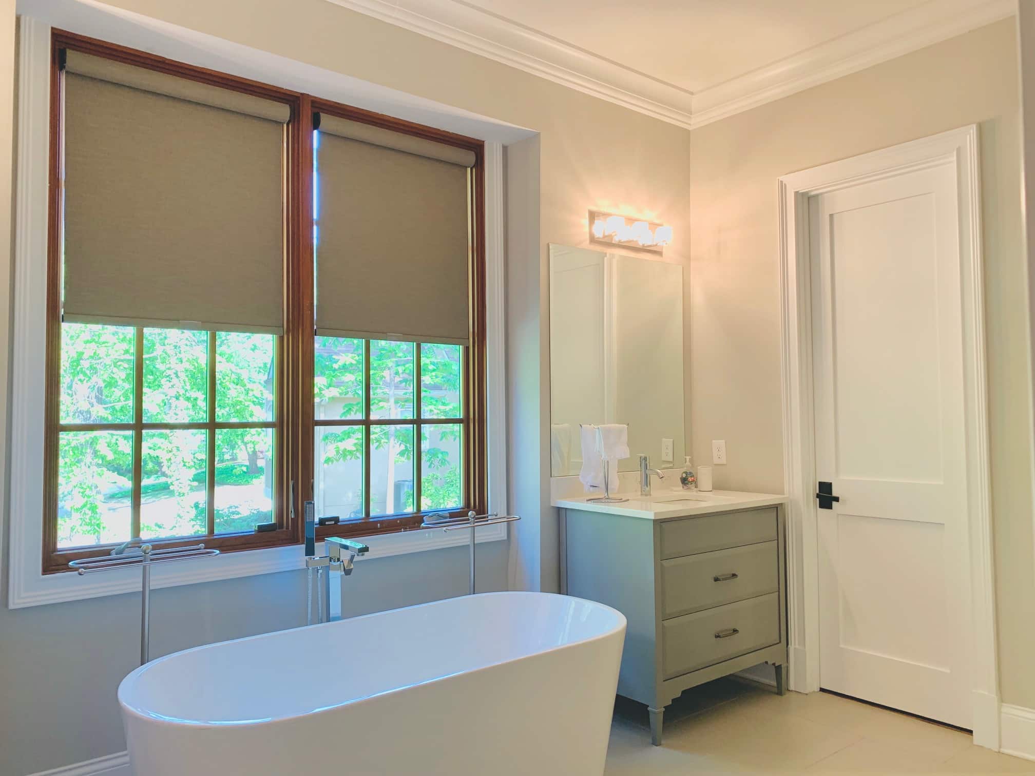 Custom, Cordless Roller Shades lifted to expose windows in a Dunwoody, GA master bathroom