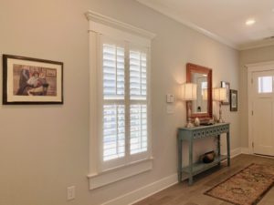 White, Hardwood Plantation Shutters with 3.5 inch louvers and divider rails in a Decatur, GA entryway