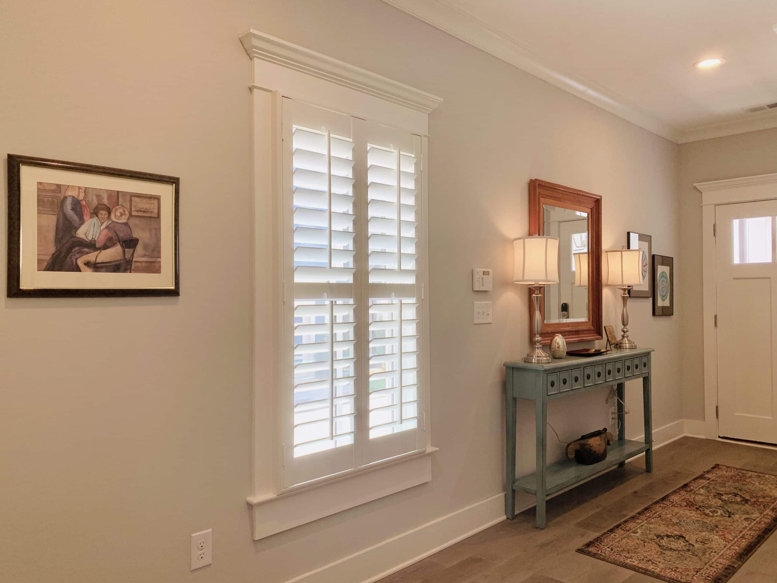 White, Hardwood Plantation Shutters with 3.5 inch louvers and divider rails in a Decatur, GA entryway