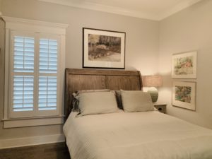 White, Tapered Hardwood Plantation Shutters with 3.5 inch louvers and divider rails in a Decatur, GA bedroom