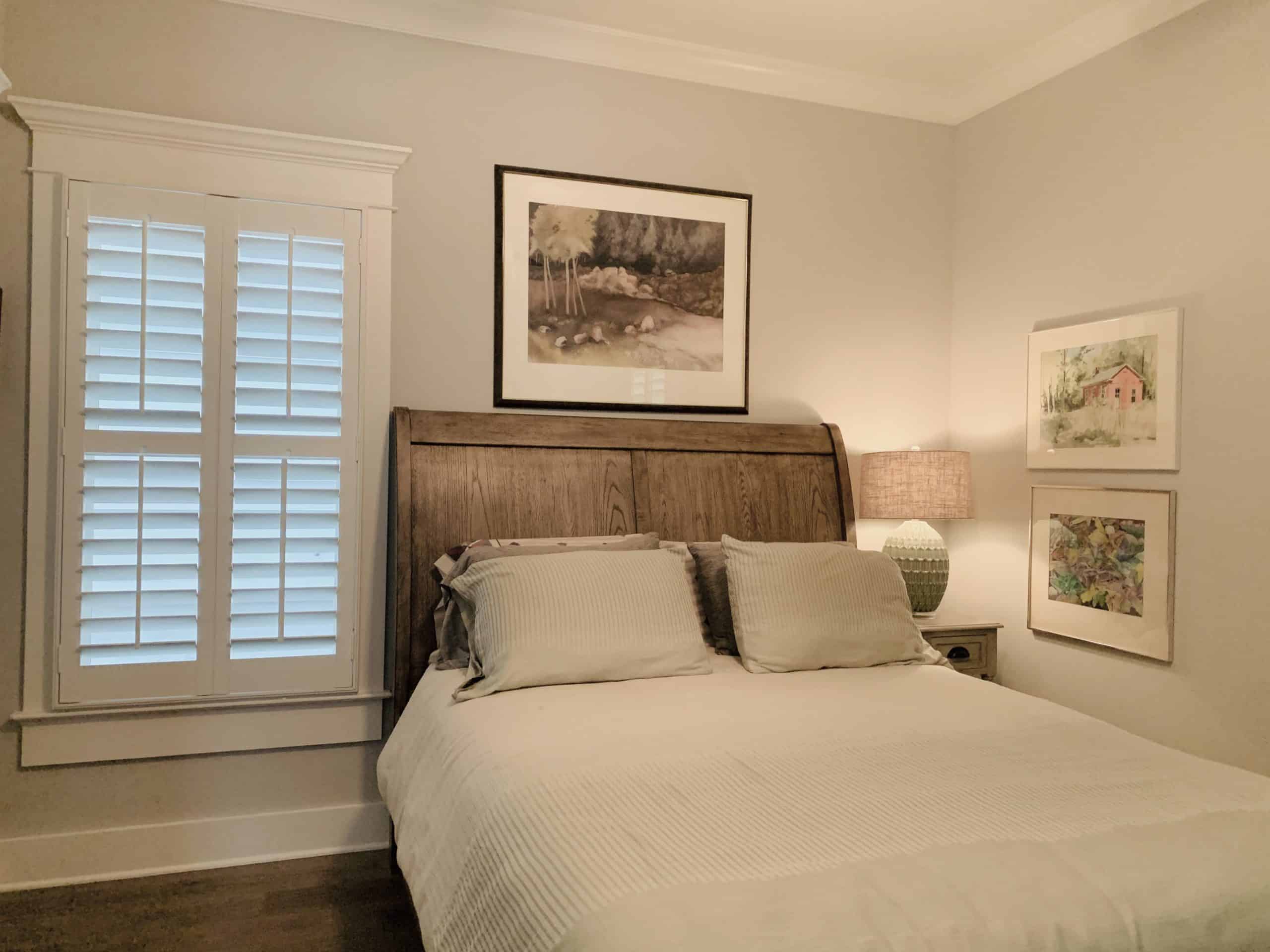 White, Tapered Hardwood Plantation Shutters with 3.5 inch louvers and divider rails in a Decatur, GA bedroom