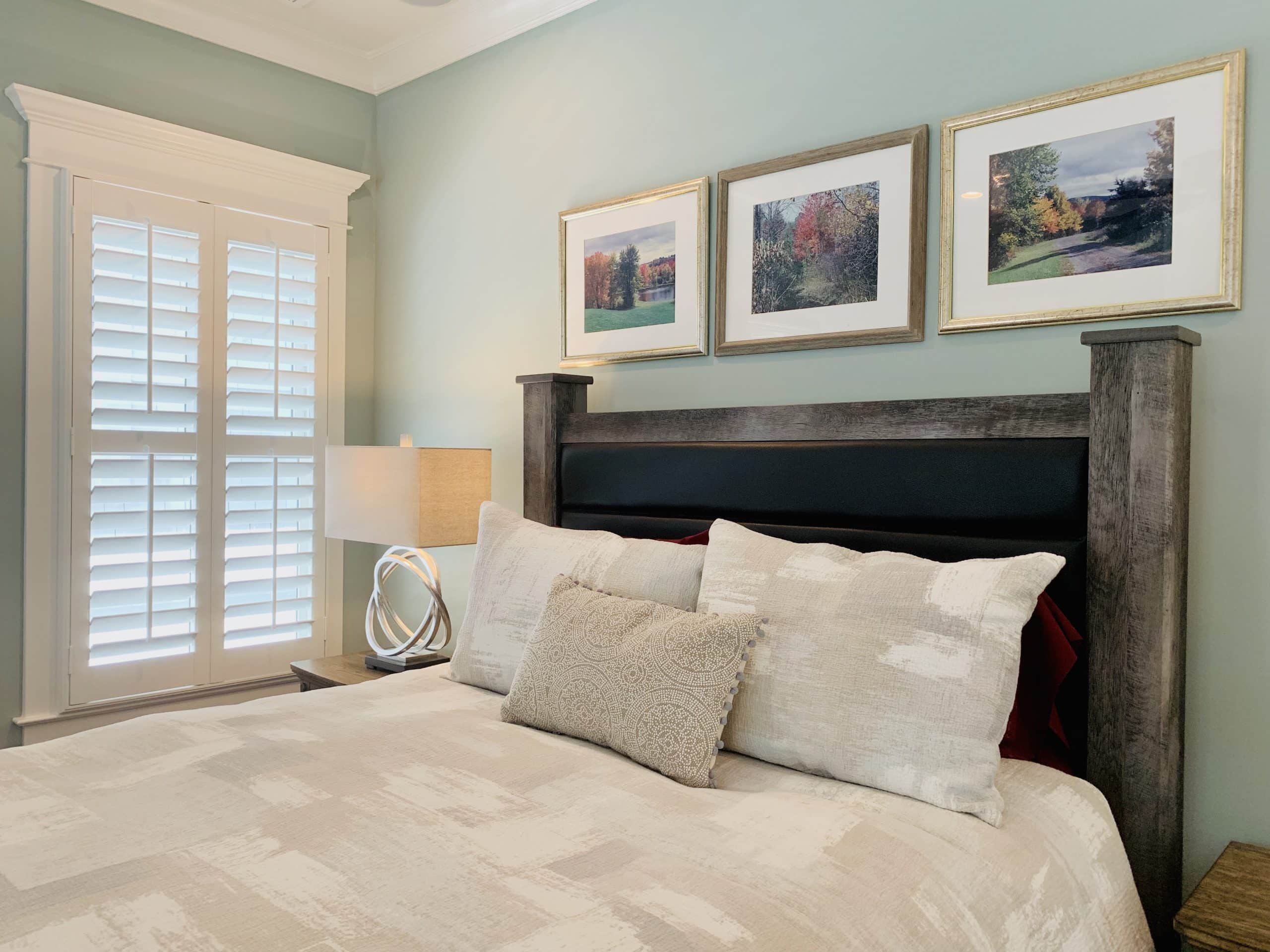 White, Tapered Hardwood Plantation Shutters with 3.5 inch louvers and divider rails in a Decatur, GA master bedroom