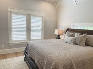 Hardwood Plantation Shutters featuring 3.5 inch louvers and hidden tilt rods, also known as Superview Shutters, in a neutral-toned Atlanta, GA guest room