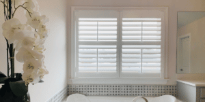 White, Hardwood Plantation Shutters with 3.5 inch louvers and divider rails in a Roswell, GA master bathroom