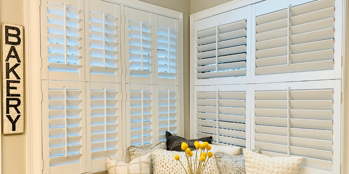 Hardwood Plantation Shutters featuring 3.5 inch louvers and split tilt rods in a white living area in a Decatur, GA home