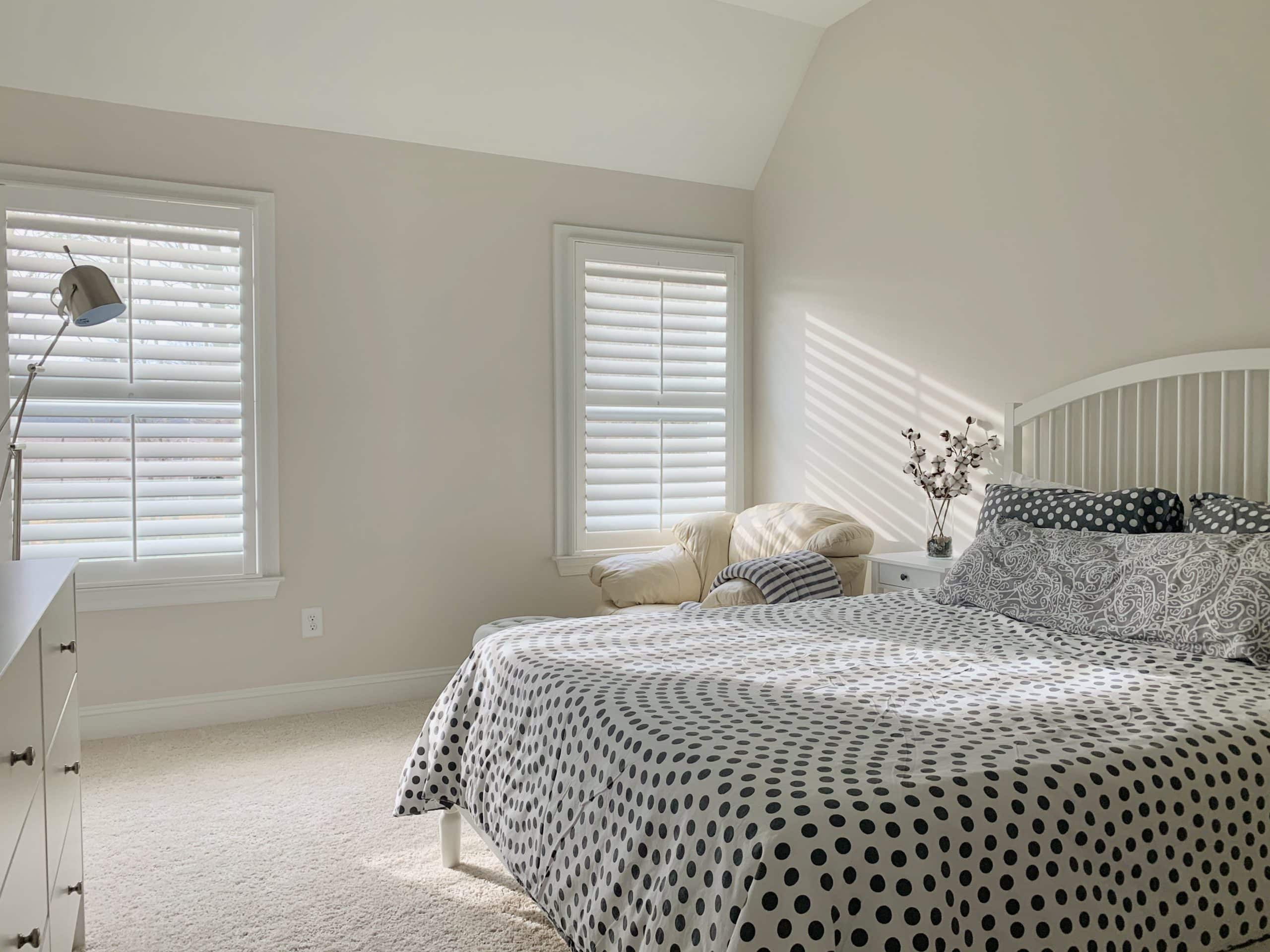 White Hardwood Plantation Shutters with 3.5 inch louvers and divider rails in an Atlanta, GA bedroom