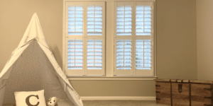 White, Hardwood Plantation Shutters with 3.5 inch louvers and divider rails in a Decatur, GA playroom