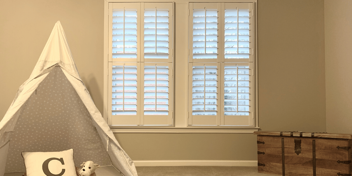 White, Hardwood Plantation Shutters with 3.5 inch louvers and divider rails in a Decatur, GA playroom