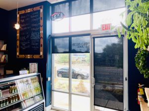 Dark Roller Shades adorn the front windows and door of juice retailer in Nashville, TN