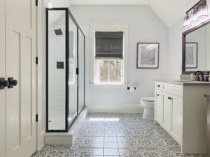 Dark Natural Woven Shades, also known as Tropical Woven Shades, lifted to expose a window in an Atlanta, GA bathroom