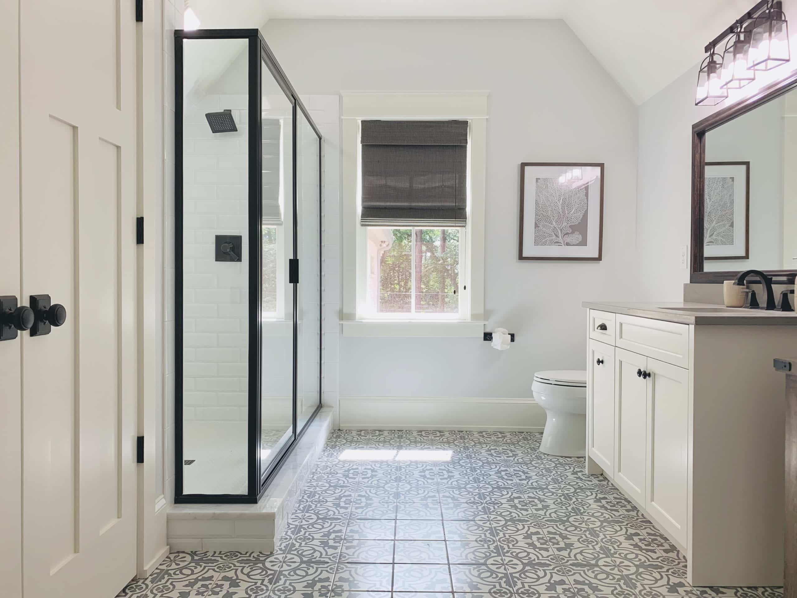 Dark Natural Woven Shades, also known as Tropical Woven Shades, lifted to expose a window in an Atlanta, GA bathroom
