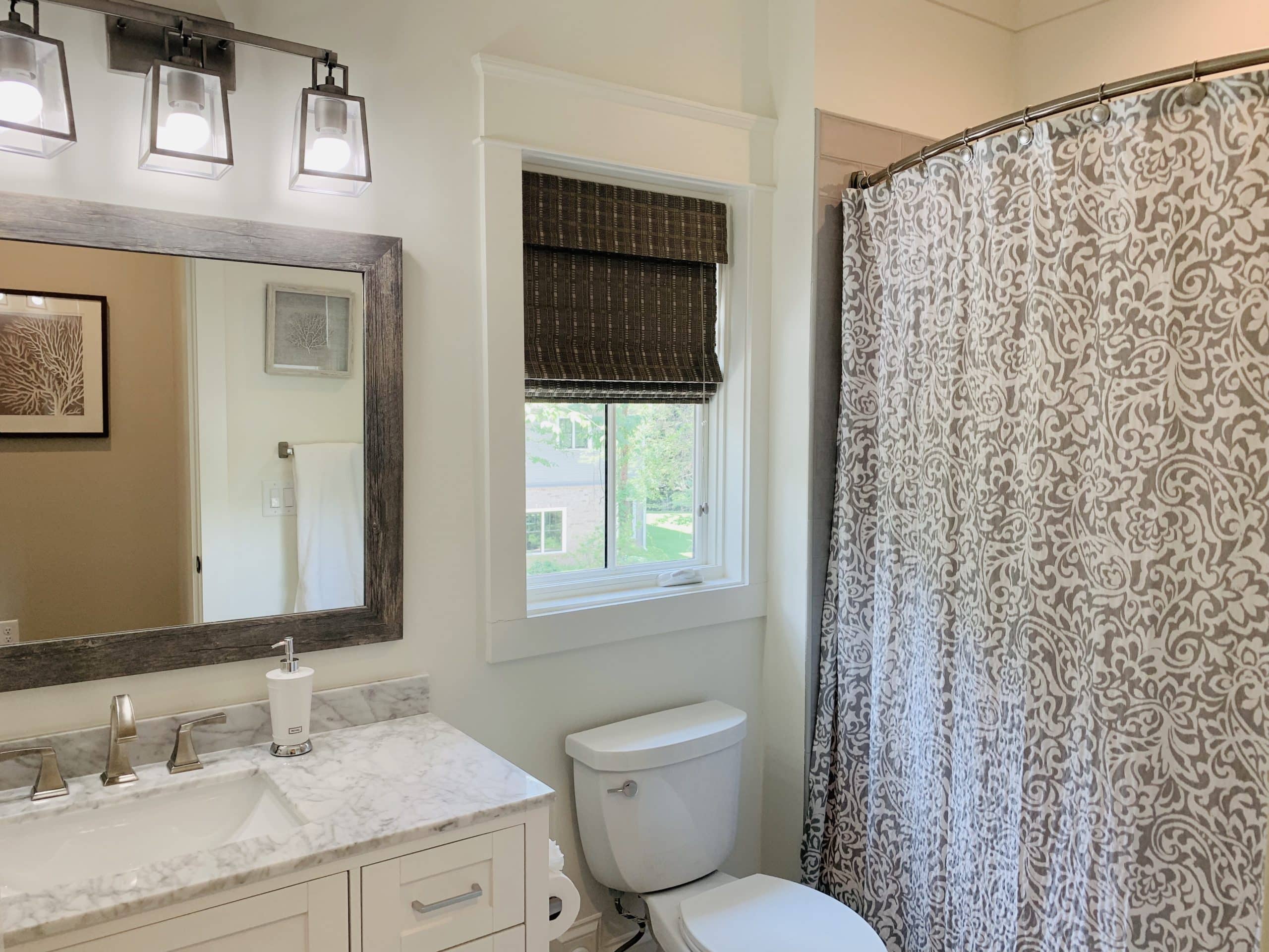 Dark Brown Tropical Woven Shades, also known as Natural Woven Shades, in a light-colored Atlanta, GA bathroom