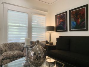 Layered Shades, also known as Zebra Shades, cover two windows in a contemporary living room in Atlanta, GA