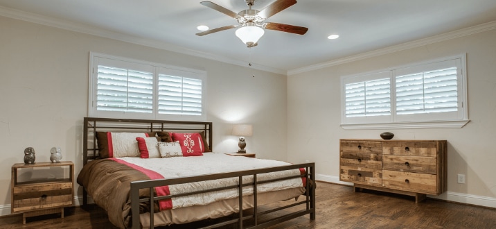 White, Hardwood Plantation Shutters with 3.5 inch louvers in a bedroom