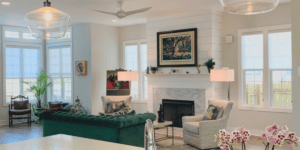 Light-filtering gray roller shades in a bright and spacious Atlanta, GA living room with a fireplace