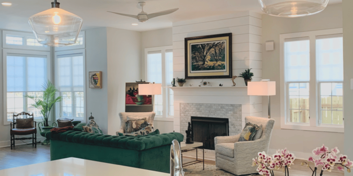 Light-filtering gray roller shades in a bright and spacious Atlanta, GA living room with a fireplace