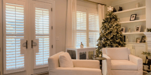 White, Hardwood Plantation Shutters featuring 3.5 inch louvers and divider rails, in a Christmas-decorated Nashville, TN home.