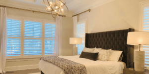 White, Hardwood Plantation Shutters with 3.5 inch louvers and divider rails in a Nashville, TN master bedroom