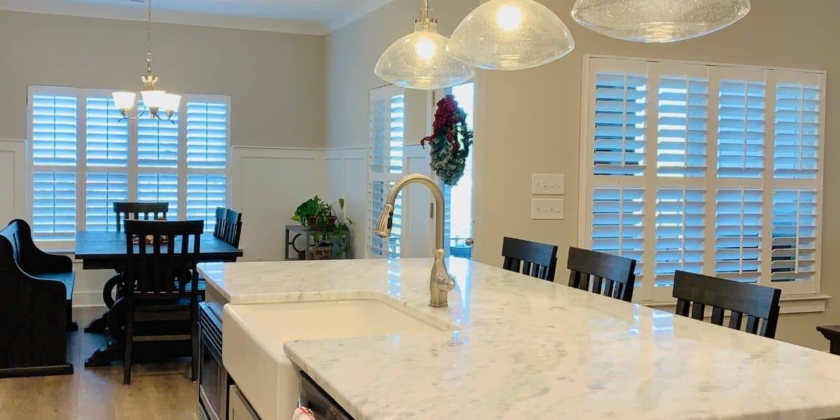 White, Hardwood Plantation Shutters featuring 3.5 inch louvers, divider rails and split tilt rods, in a spacious Murfreesboro, TN great room