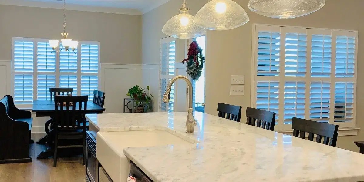 White, Hardwood Plantation Shutters featuring 3.5 inch louvers, divider rails and split tilt rods, in a spacious Murfreesboro, TN great room