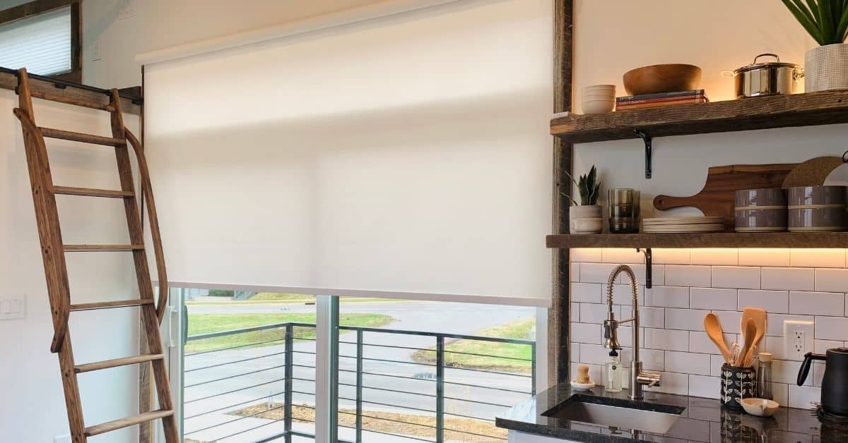 White Roller Shade covers a sliding door in a small, contemporary loft in Nashville, TN