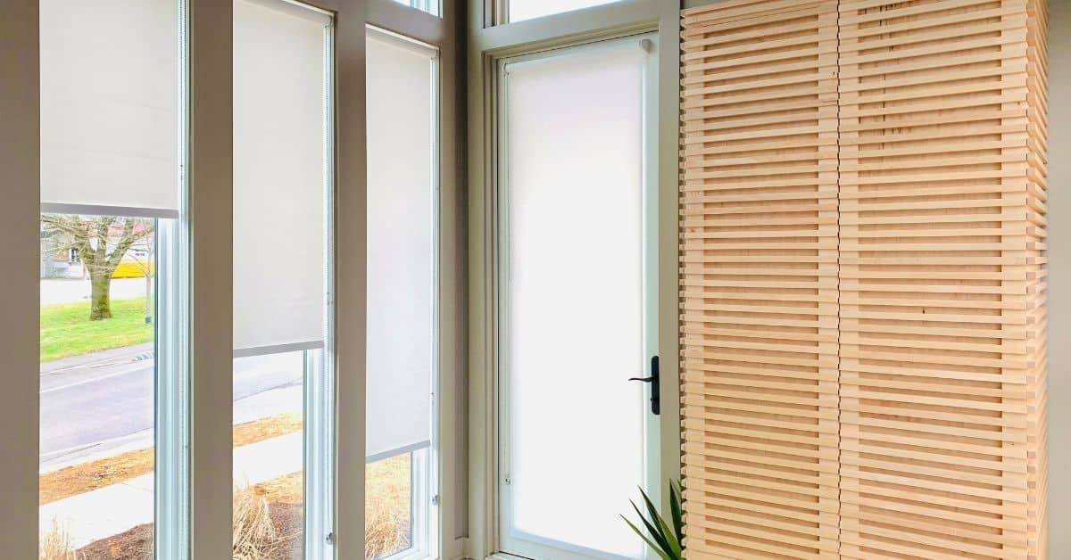 Roller Shades add a sleek, modern touch to these long, rectangular windows in a modern entryway