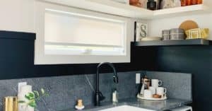 White Custom Roller Shade gently diffuses light into this modern kitchen with charcoal trim