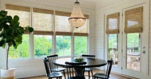 Dark Natural Woven Shades, also known as Tropical Woven Shades, with a 6 inch valance, lifted to expose windows in a large Franklin, TN dining room