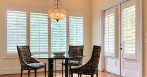 Hardwood Plantation Shutters featuring 4.5 inch louvers and door handle cutouts in a spacious Brentwood, TN dining room