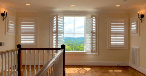 Hardwood Plantation Shutters featuring 4.5" louvers and divider rails in a sunlit Brentwood, TN, loft