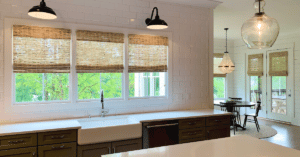 Dark Natural Woven Shades, also known as Tropical Woven Shades, with a 6 inch valance, lifted to expose windows in a Franklin, TN kitchen and dining room