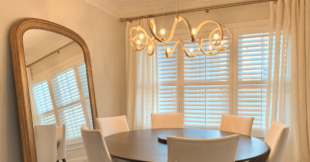 White, Hardwood Plantation Shutters with 3.5 inch louvers and divider rails in a white dining room