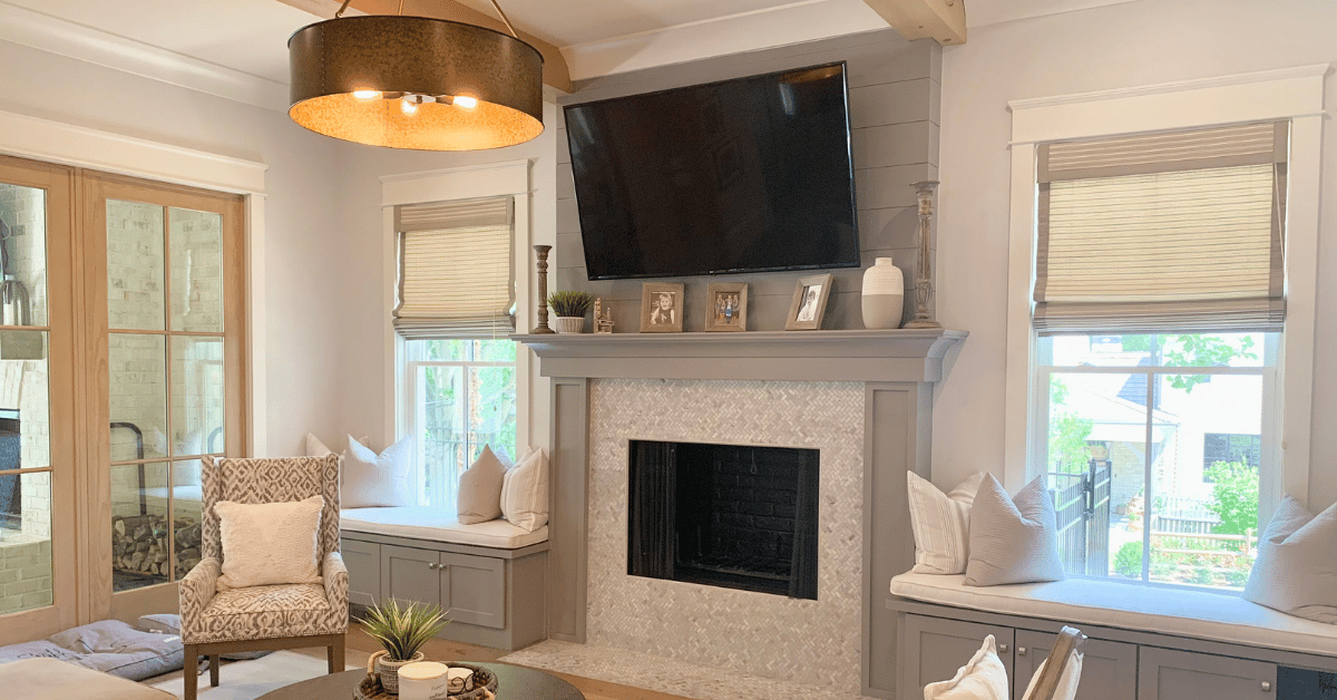 Tropical Woven Shades, also known as Natural Woven Shades, with edge-banding, raised to uncover portion of the windows in a large Atlanta, GA living room