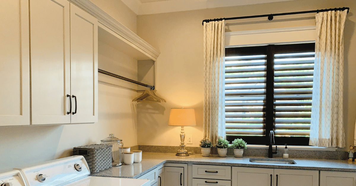 Dark-Stained Hardwood Plantation Shutters with 3.5 inch louvers and a hidden tilt rod, also known as Superview Shutters, in a kitchen