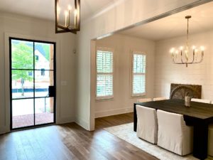 White Hardwood Plantation Shutters with 3.5 inch louvers and divider rails in a Canton, GA dining room