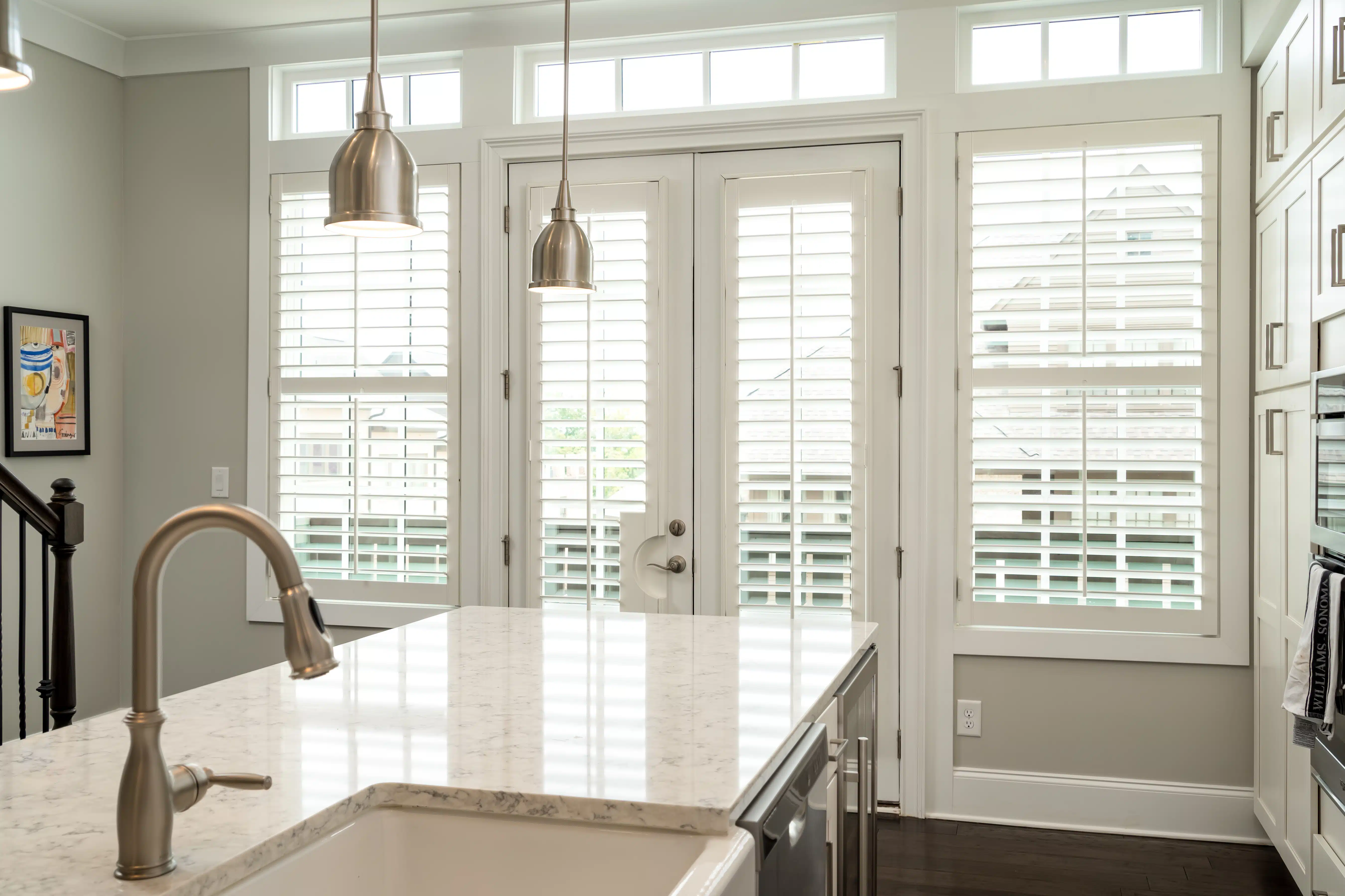 White, Hardwood Plantation Shutters with a radial cut-out on French doors in an Atlanta, GA kitchen
